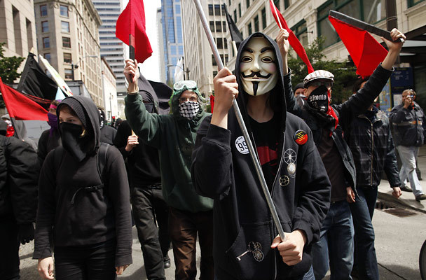 anonymous protesters marching 